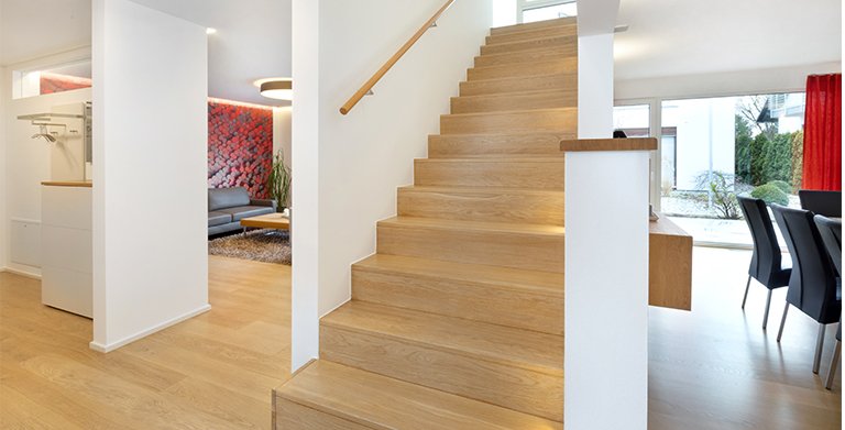 Die gerade Treppe bildet den Mittelpunkt des Einfamilienhauses und zoniert die verschiedenen Aufenthaltsbereiche Copyright: TALBAU-Haus GmbH